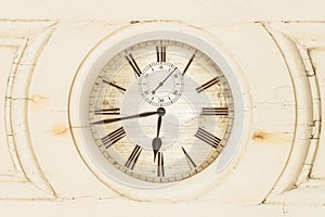 Old clock enclosed in wooden panel