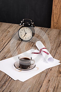 Old clock, hat, coffee and paper sheets