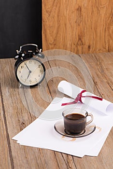Old clock, hat, coffee and paper sheets