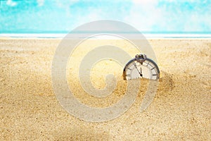 Old clock in the sand, the concept of time passes by infinity, the selected focus is very small depth of field