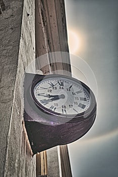 Old clock in sun and rainbow