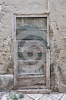 Old closed wooden rectangular door, chain and lock
