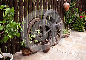 Old coach wheel around barn. Bulgaria