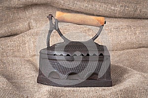 The old coal iron on fabric background