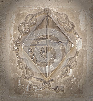 The old coat of arms on the wall in the cathedral of Beziers