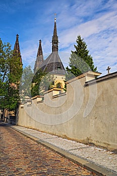 Old cobbles road the Church of Saint Peter and Paul. Summer landscape photo on a sunny morning. Vysehrad `Upper Castle