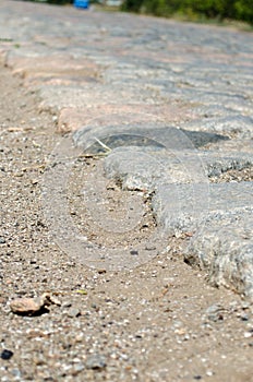 Old cobblestone road paved with stones