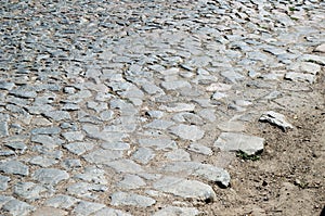 Old cobblestone road paved with stones