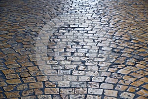 Old cobblestone street background texture backlit