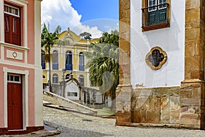 Old cobblestone street with houses in colonial architecture