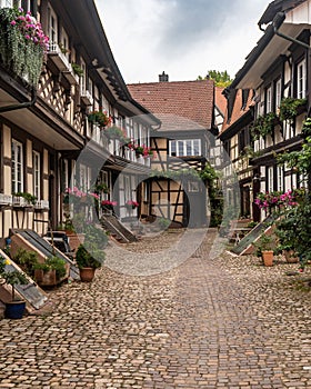 an old cobblestone street is lined with old buildings