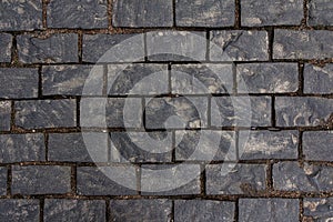 Old cobblestone tile texture in old town. City pavement background. Abstract granite stone brick pattern. Street sidewalk texture