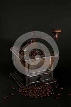 Old coffee grinder on black