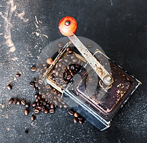 Old coffee grinder on black table