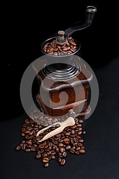 Old coffee grinder on the kitchen table. Iconic accessories for brewing black coffee