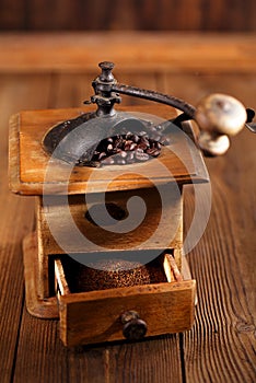 Old coffee mill with coffee beans, close-up