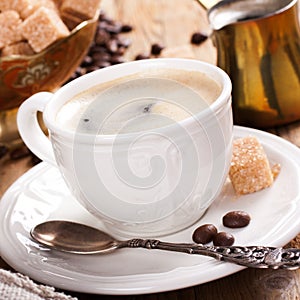 Old coffee pot and cup on wooden rustic background