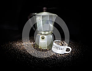 Old coffeepot with cup and coffee beans