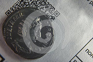 an old coin on a sheet of paper with a cuar code