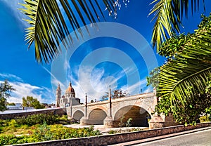 Old colonial bridge and Parish of the Light in Lagos de Moreno, Mexico photo