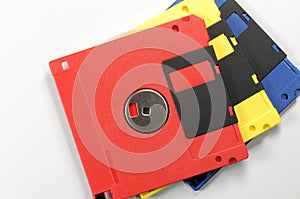 Old color floppy disk. Red, yellow and blue.