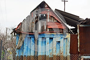 Old colored rural building of wooden planks and metal