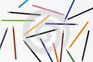 Old colored wooden pencils on the white board background