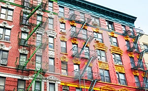 Old colorful buildings with fire escapes, New York City, USA