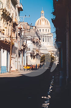 Old colorful buildings on a street leading to the Capitol building in Havana