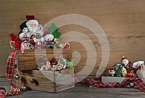 Old colorful christmas decoration with santa on wooden background.