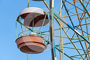 Old colorful ferris wheel in amusement park. Multicolour soviet carousel.