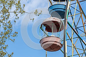 Old colorful ferris wheel in amusement park. Multicolour soviet carousel.