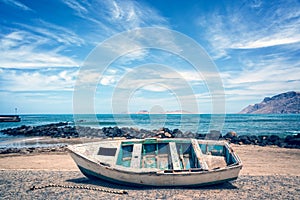 Old colorful fishing boat, atlantic ocean in the background, Lanzarote, Canary islands, Spain