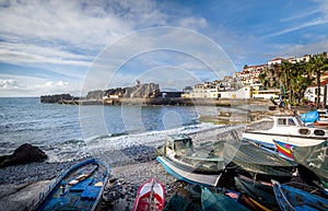 Old colorful fishing boats laying on the shore in Camara de Lobos