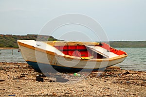 old colorful painted boat on a beach