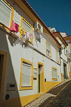 Old colorful terraced house with clothes hanging on window