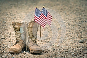 Old combat boots with dog tags and American flags