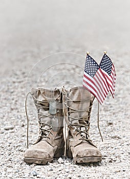 Old combat boots with dog tags and American flags