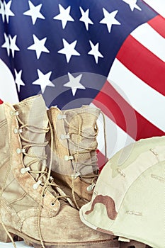 Old combat boots and helmet with American flag