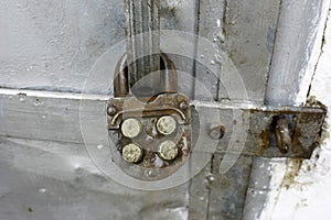 Old combination lock on metal old doors, close-up photo