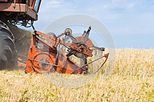 Old combine harvester removes wheat