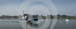 Old commercial fishing boat leaving to go to sea