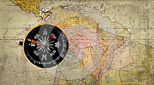 Old compass on antique cracked world map. Vintage still life. Top view