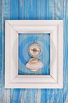 Old Compass in Photo frame on blue background