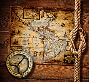 Old compass and rope on vintage map