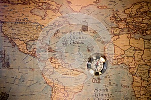 Old compass on vintage map. Adventure stories background.