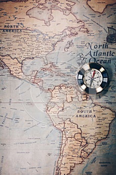 Old compass on vintage map. Adventure stories background. Retro