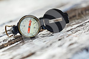 Old compass on wooden table