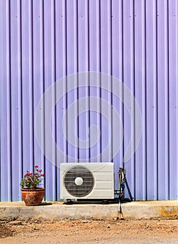 Old compressor air-conditioner and Flower Pot on zinc wall