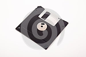 Old computer and data storage technology, black magnetic floppy disk 3Â½ inches, isolated on white background